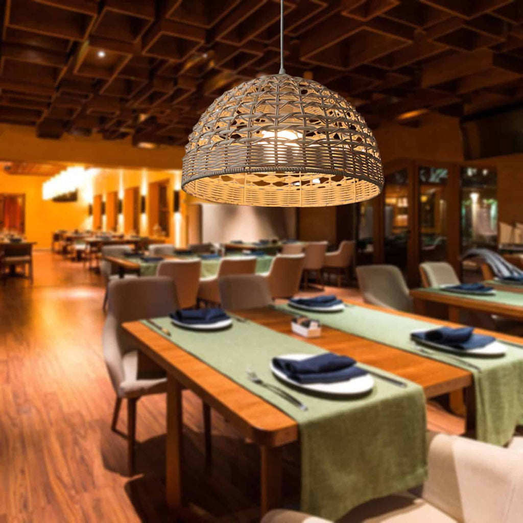 Handwoven rattan and wicker dome lamp shade hung over a table