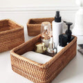 Rectangular honey rattan baskets holding bathroom products