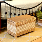 Rectangular hand woven rattan storage stool with a lift off lid on wood feet