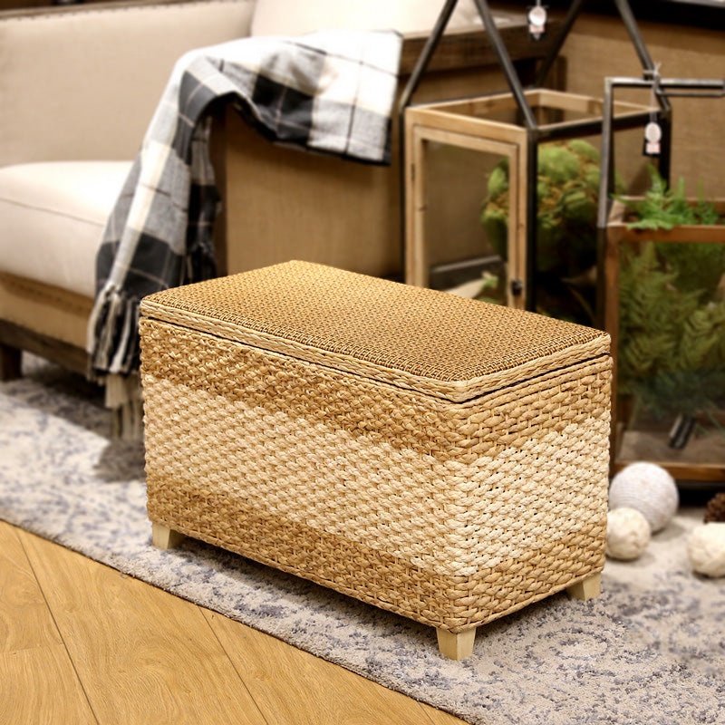 Rectangular hand woven rattan storage stool with a lift off lid on wood feet