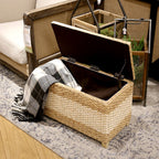 Rectangular hand woven rattan storage stool with a lift off lid on wood feet