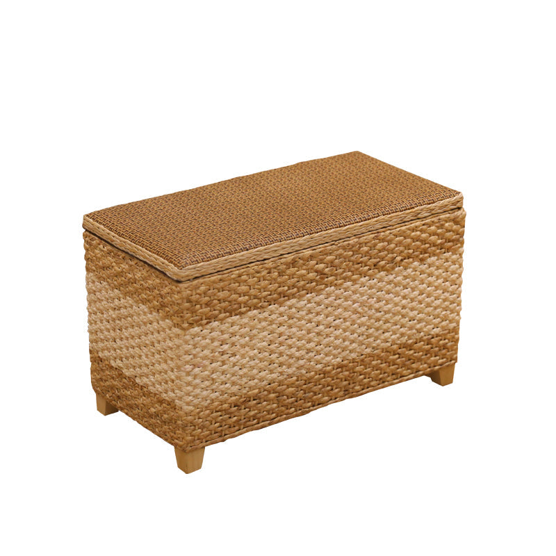 Rectangular hand woven rattan storage stool with a lift off lid on wood feet