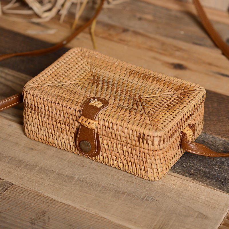 Compact rectangular hand woven rattan crossbody pouch with clean edges