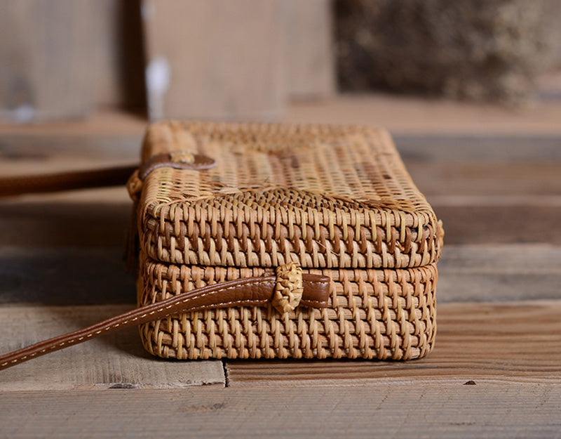 Compact rectangular hand woven rattan crossbody pouch with clean edges