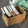 Rectangular woven rattan storage basket holding books