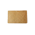 Rectangular hand woven golden seagrass placemat with a ribbed texture