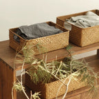 Rectangular woven shelf baskets holding folded clothes