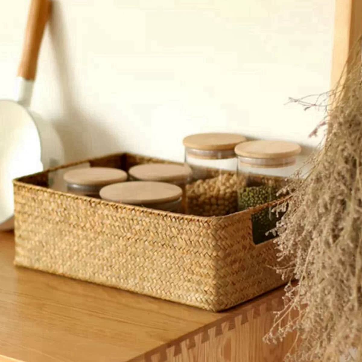 Rectangular woven shelf baskets holding folded clothes