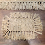 Rectangular hand woven beige straw placemat with fine fringed edges