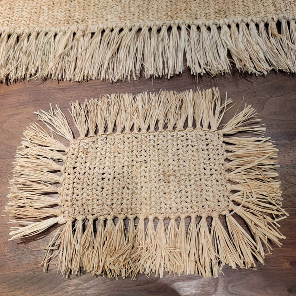 Rectangular hand woven beige straw placemat with fine fringed edges