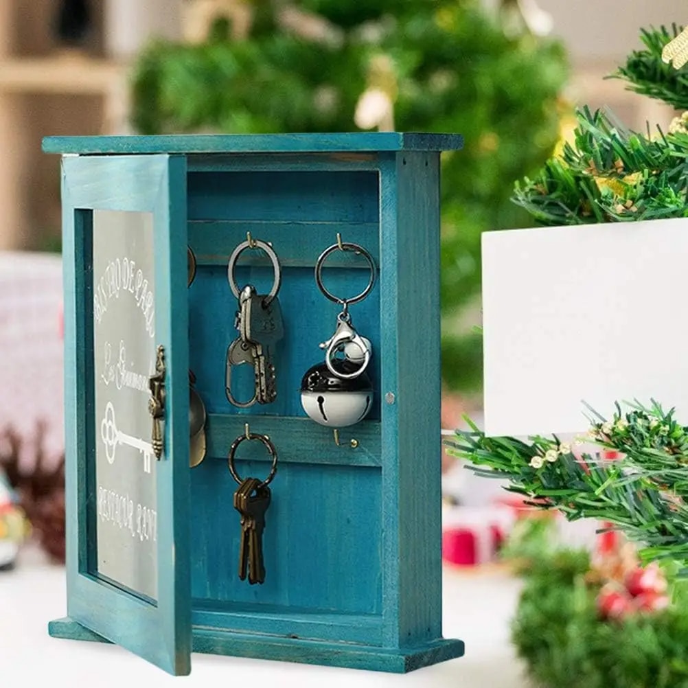 Retro blue wooden key box with a hinged door and hooks inside