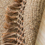 Round jute rug with a looped openwork fringe