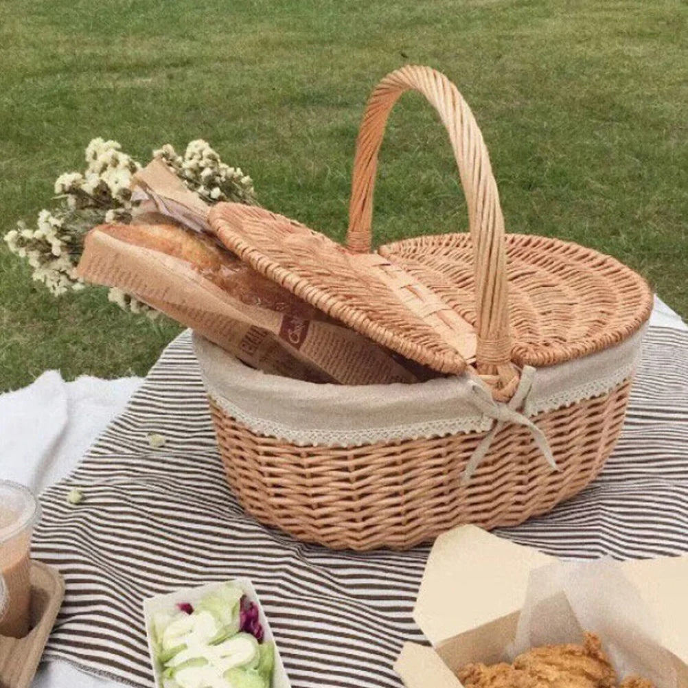 Retro wicker picnic basket with double lid and lace liner on a picnic blanket