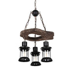 Retro chandelier made of natural wood branches on a dark iron frame with glass