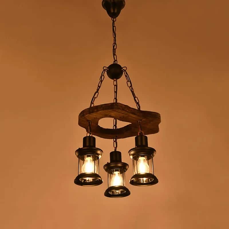 Retro chandelier made of natural wood branches on a dark iron frame with glass