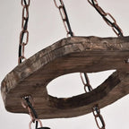 Retro chandelier made of natural wood branches on a dark iron frame with glass