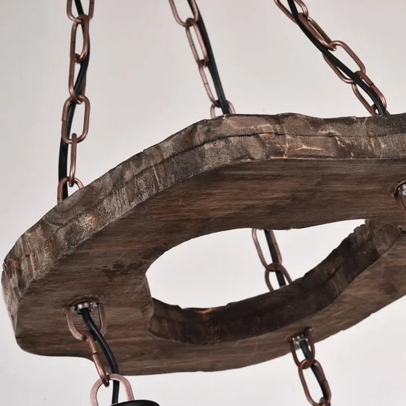 Retro chandelier made of natural wood branches on a dark iron frame with glass