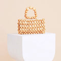 Retro structured bag with a varnished wooden frame and woven rattan body
