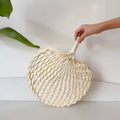 Round cream woven palm hand fan with a slim tied handle