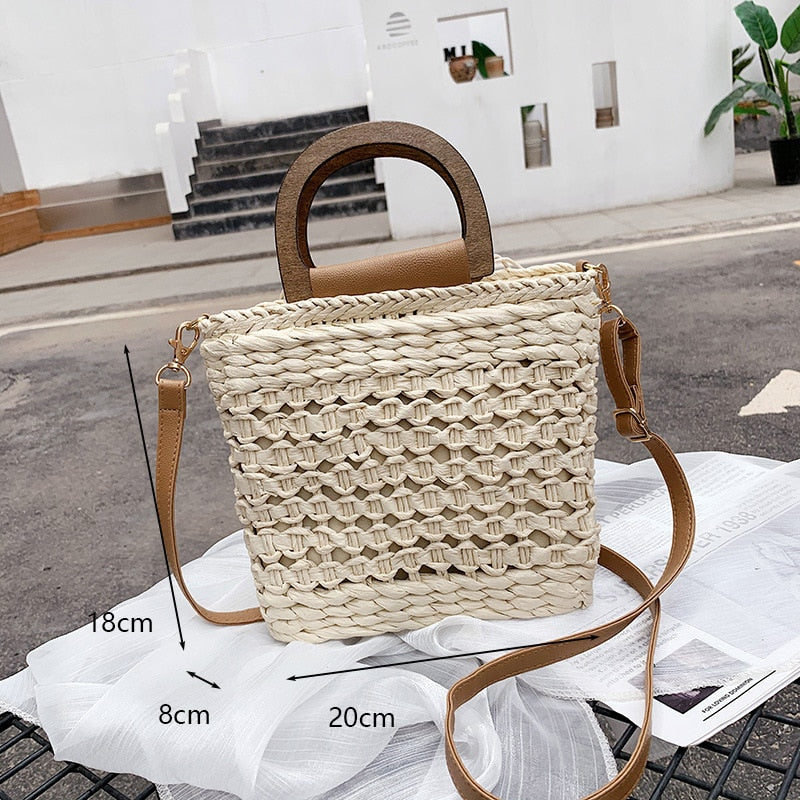 Rounded retro woven straw bag with a varnished wooden handle and shoulder strap