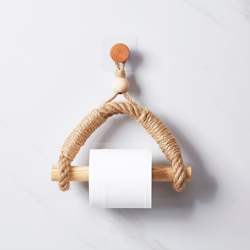 Rope loop toilet paper holder with a wood dowel hanging from a round wood wall knob