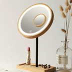 Round LED makeup mirror with 3x magnifier on a wood base