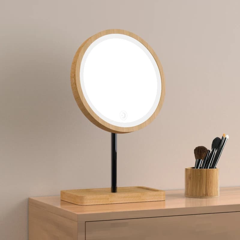Round LED makeup mirror with 3x magnifier on a wood base