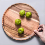 Round acacia wood plate with a contrasting natural grain
