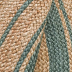 Round braided natural rug with a teal ring and thin dark stripes