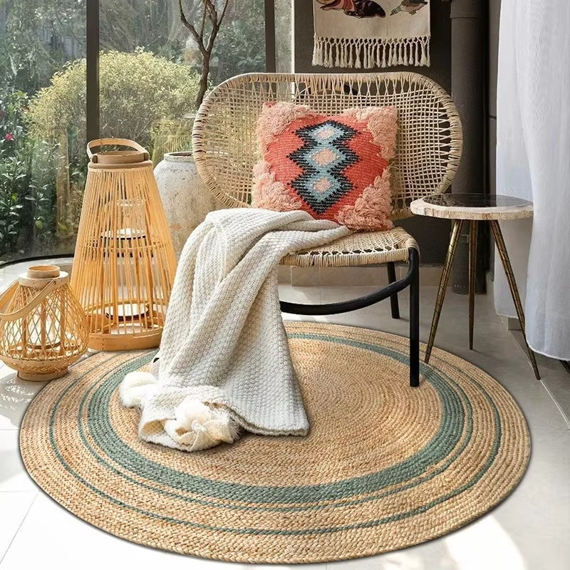 Round braided natural rug with a teal ring and thin dark stripes