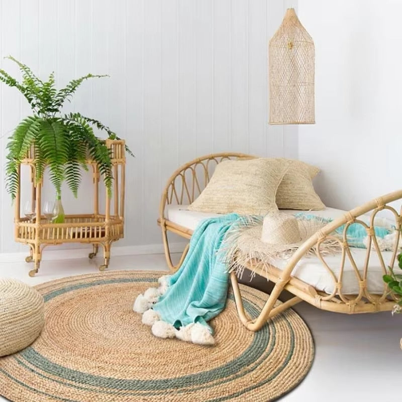 Round braided natural rug with a teal ring and thin dark stripes