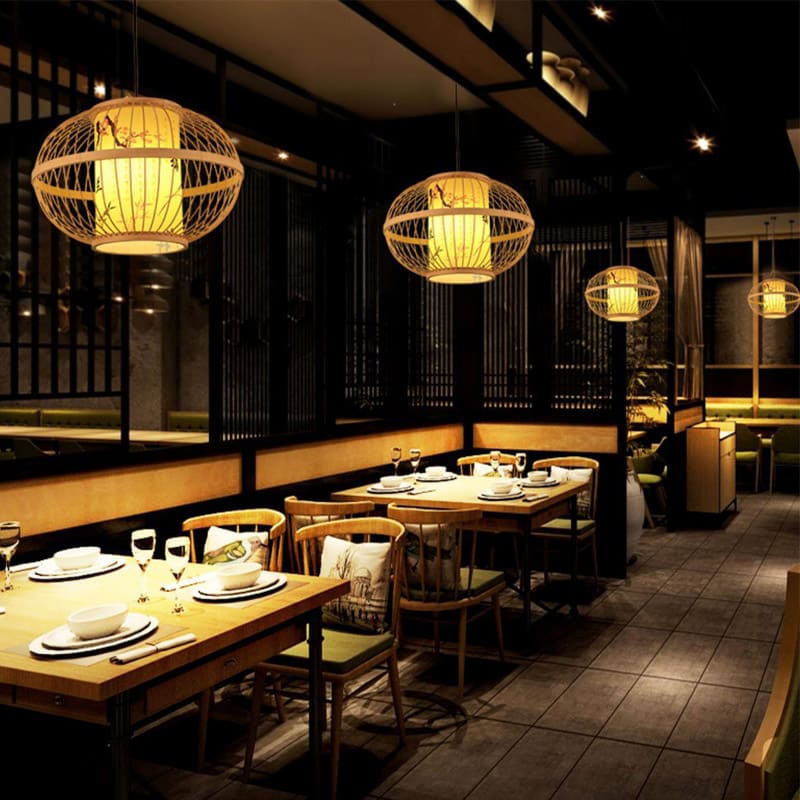Round woven bamboo lantern pendant with glowing inner shade