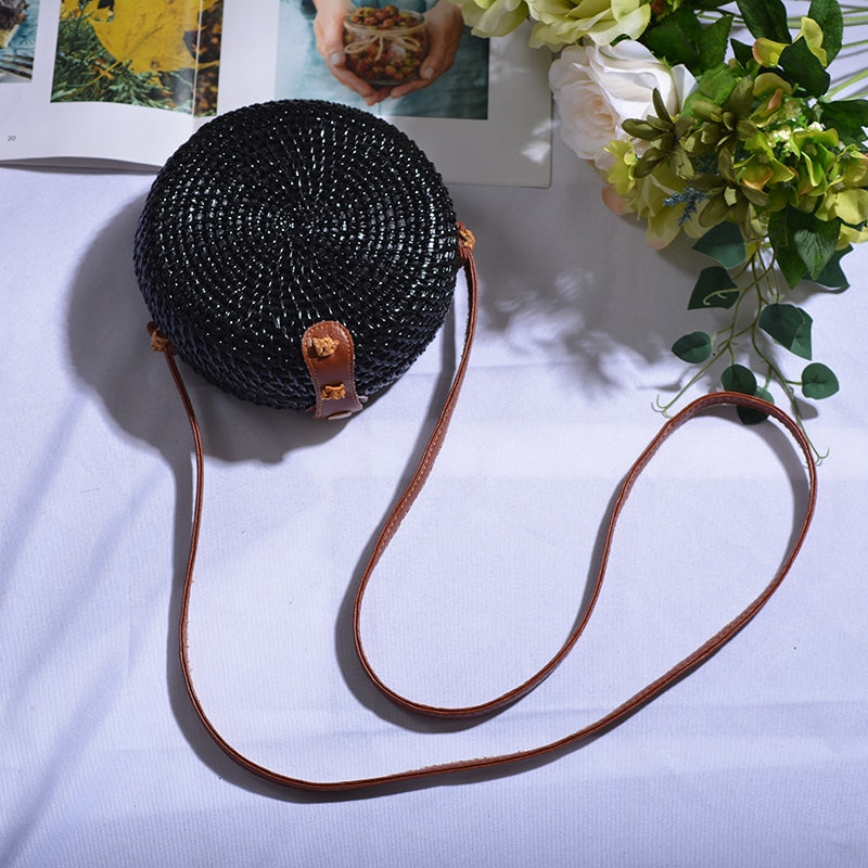 Round hand woven rattan shoulder bag in a boho style