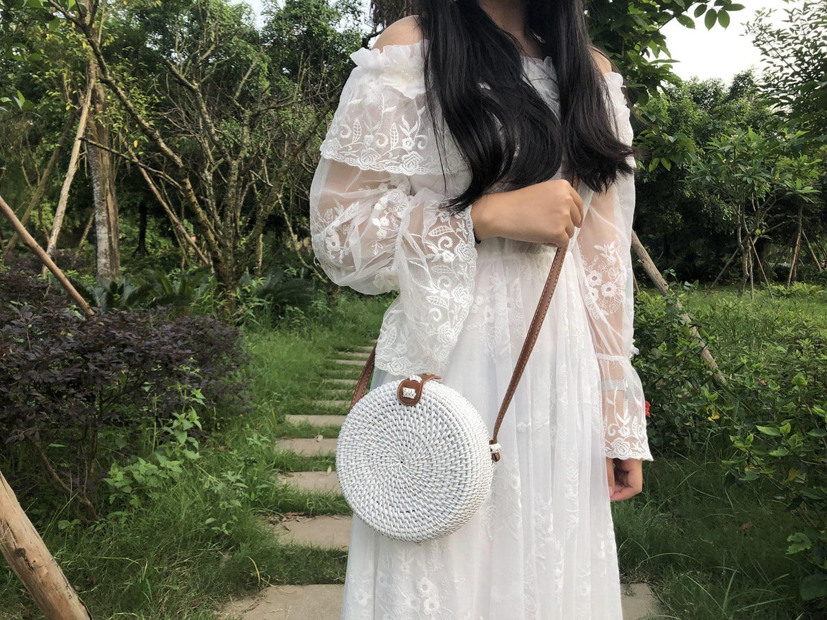 Round hand woven rattan shoulder bag in a boho style