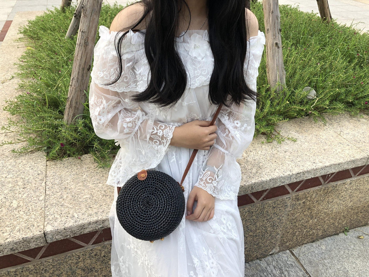 Round hand woven rattan shoulder bag in a boho style