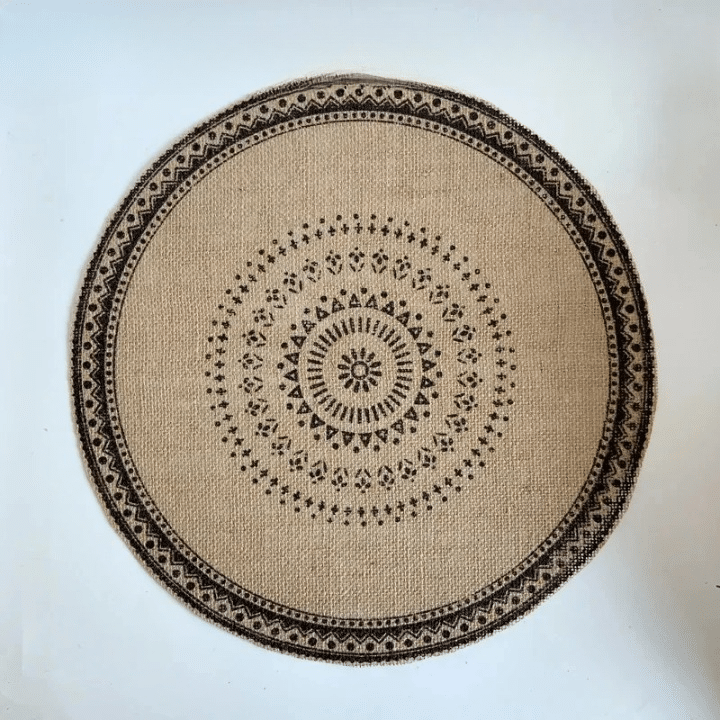 Round hand woven natural jute placemat with warm golden highlights