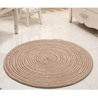 Round brown and white braided rug in a bright room