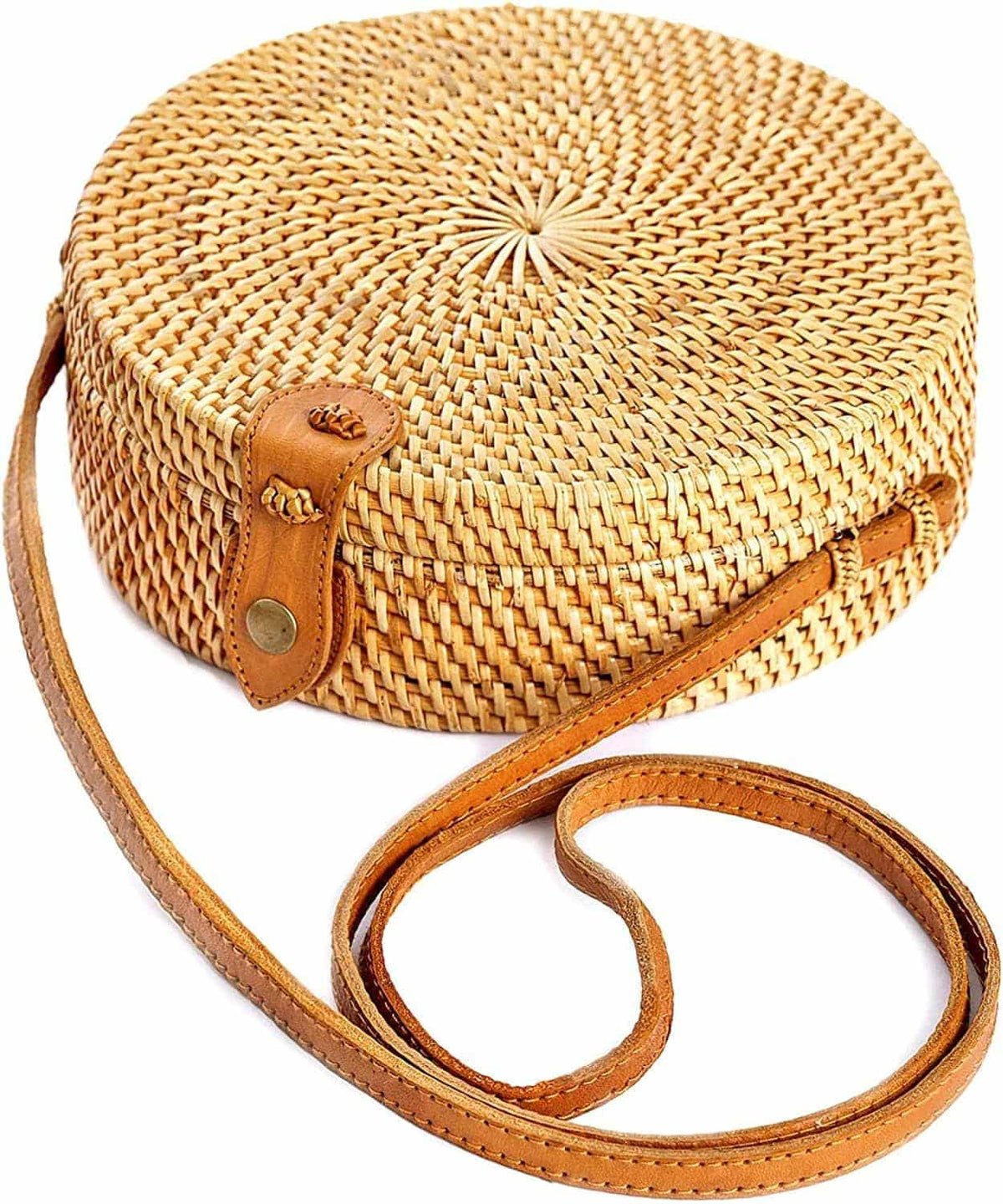 Round structured brown rattan crossbody bag with an adjustable shoulder strap
