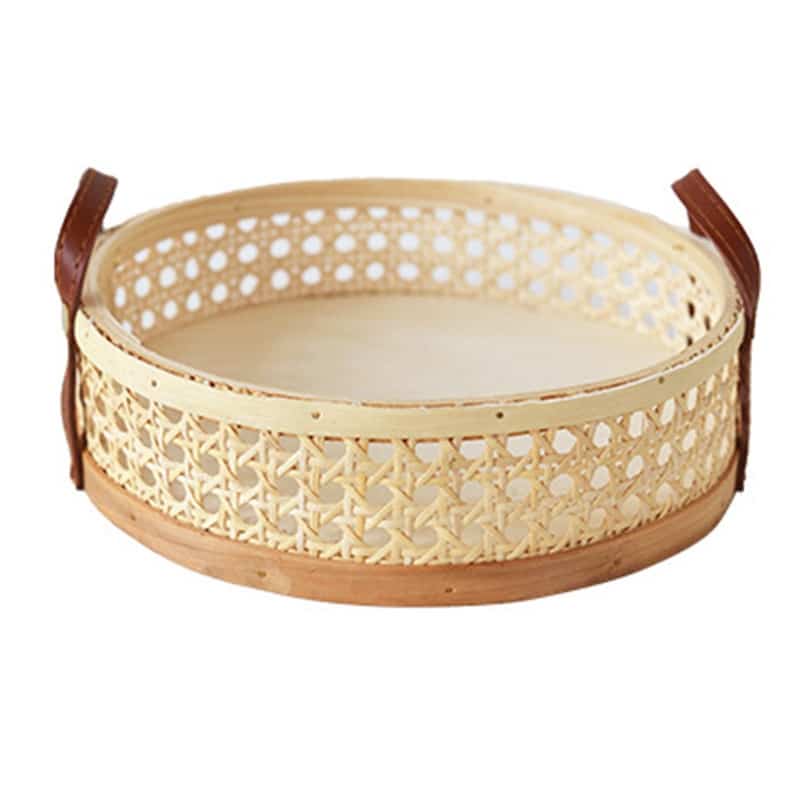 Round low cane webbing basket with leather handles in beige