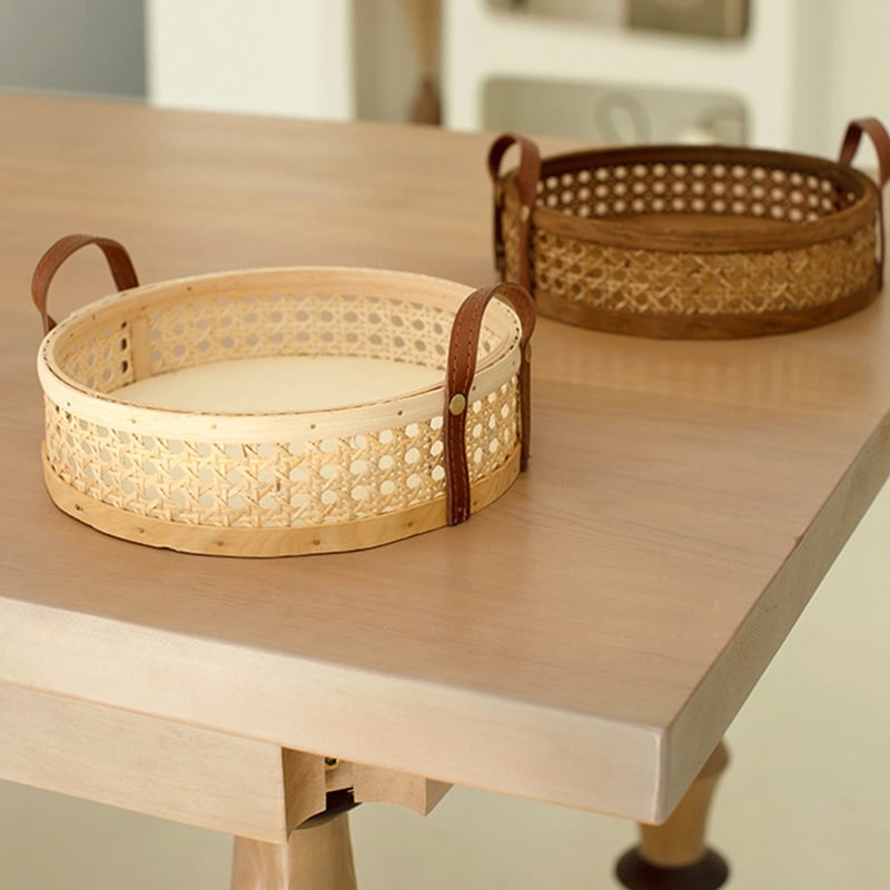 Round low cane webbing basket with leather handles in beige
