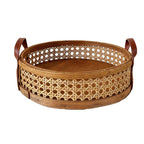Round low cane webbing basket with leather handles in brown