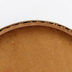 Round low cane webbing basket with leather handles in brown
