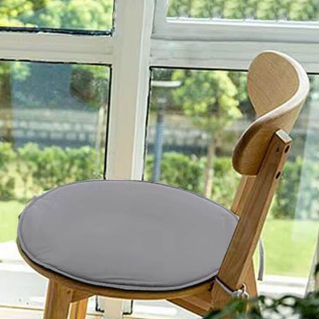 Round polyester seat cushion with tie strings for a rattan chair