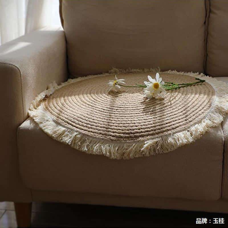 Round woven cotton and linen rug with a cream fringe
