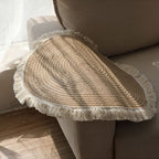 Round woven cotton and linen rug with a cream fringe