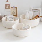 Round white cotton rope storage baskets on a vanity