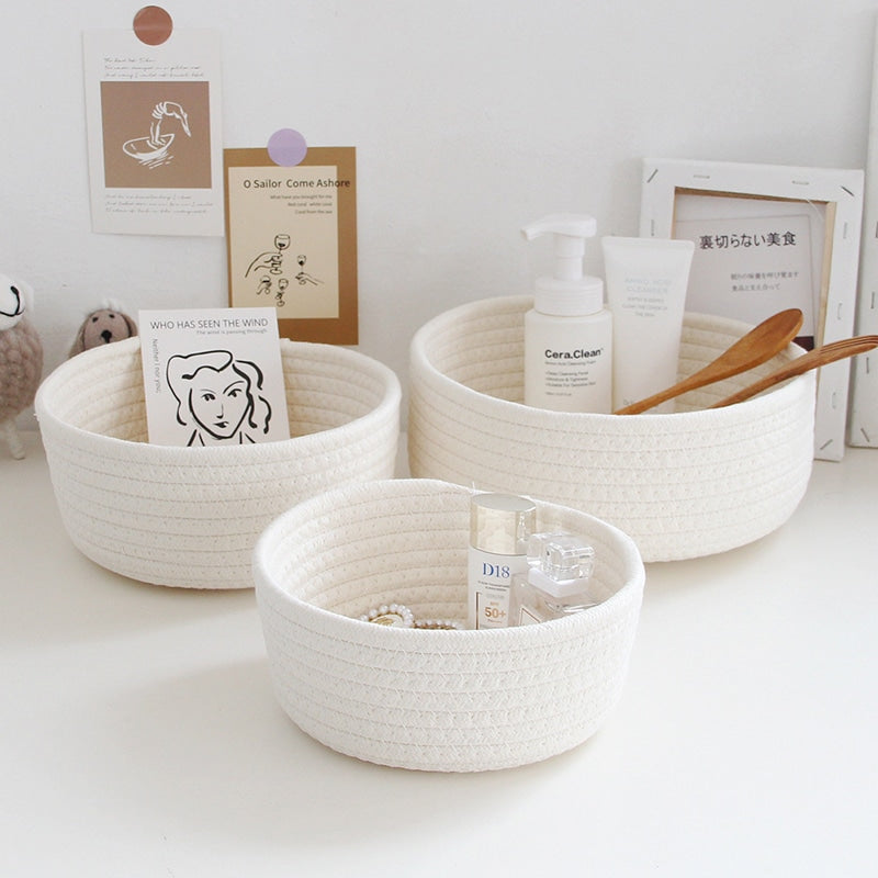 Round white cotton rope storage baskets on a vanity