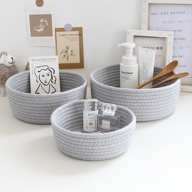Round white cotton rope storage baskets on a vanity