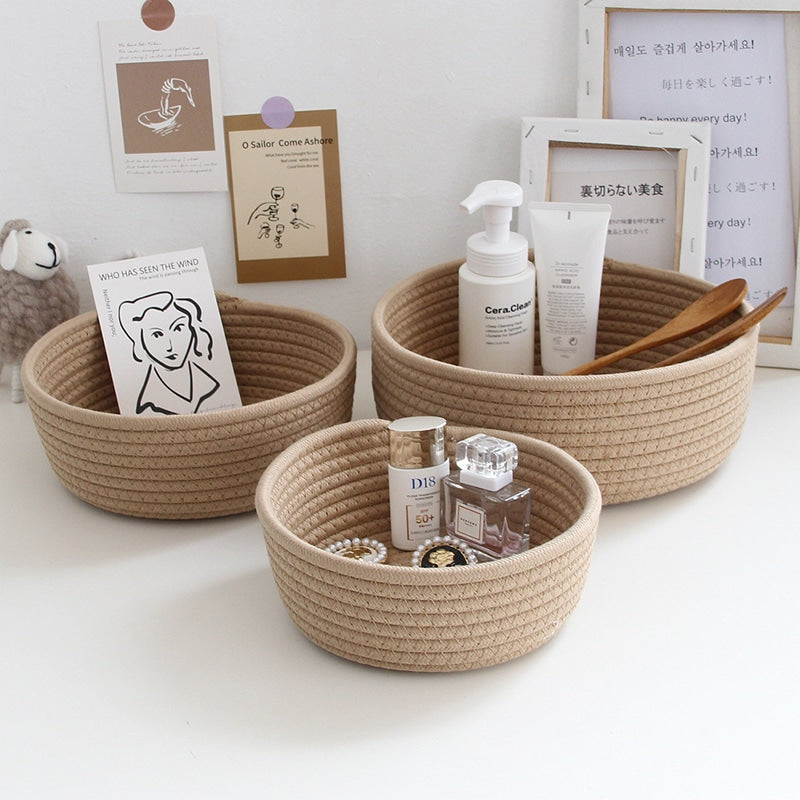 Round white cotton rope storage baskets on a vanity