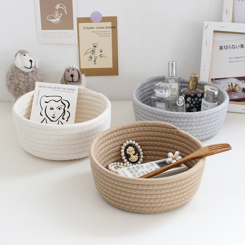 Round white cotton rope storage baskets on a vanity
